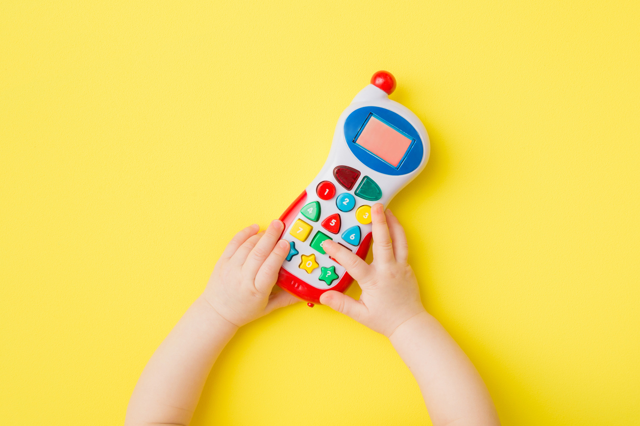 Child playing with a toy phone